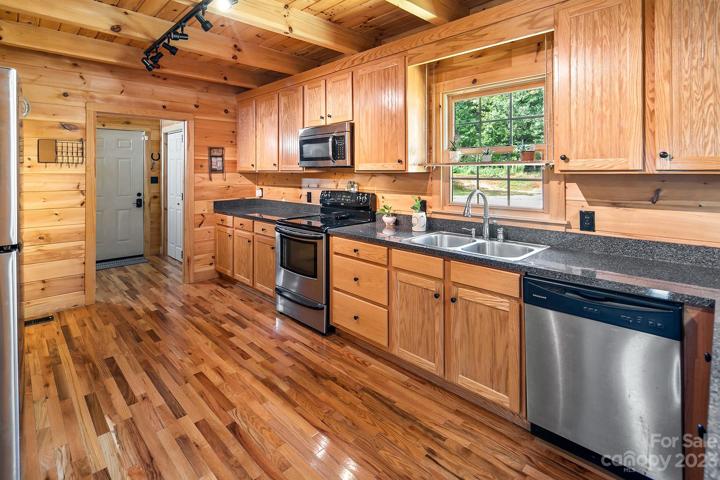 Spacious kitchen with tons of oak cabinets for storage.