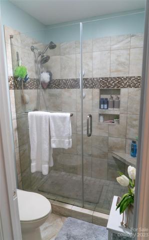 Primary tiled shower.