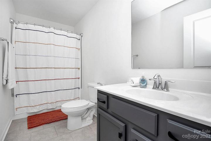 Large guest bath with tub/shower combo & storage in vanity.