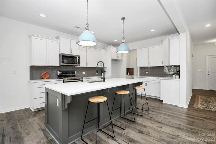 High ceilings & lots of recessed lighting on both floors really open up the space!