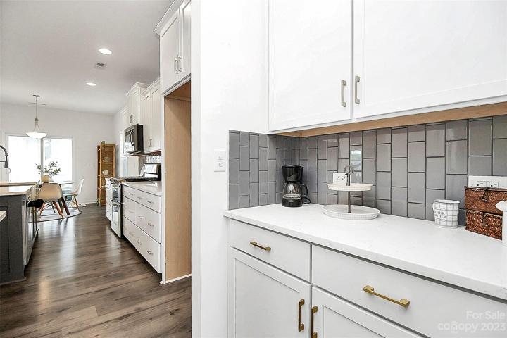 In between kitchen & formal dining space (or office), this spot offers extra storage, large pantry & more prep space.