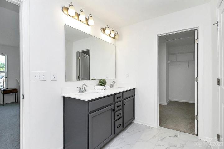 Dual vanity with lots of storage and walk in closet.