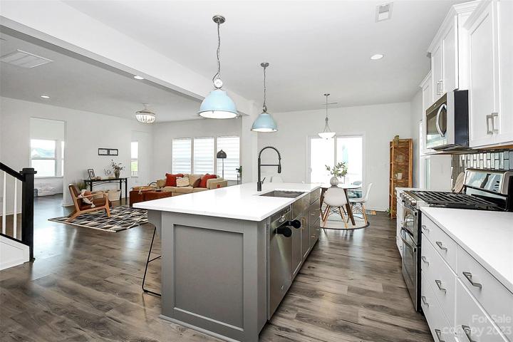 Kitchen open to eat in dining, living room, and screened in porch!
