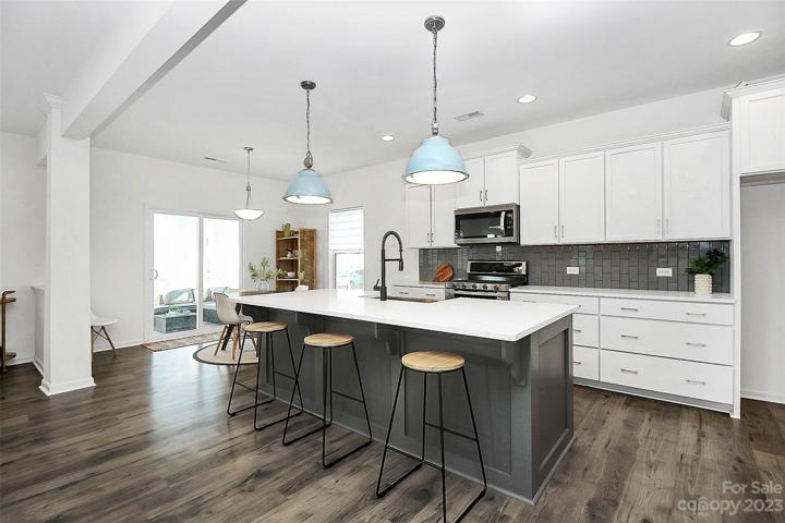 Dove cabinetry, quartz counters, vertical glass subway backsplash AND 5 burner cooktop!