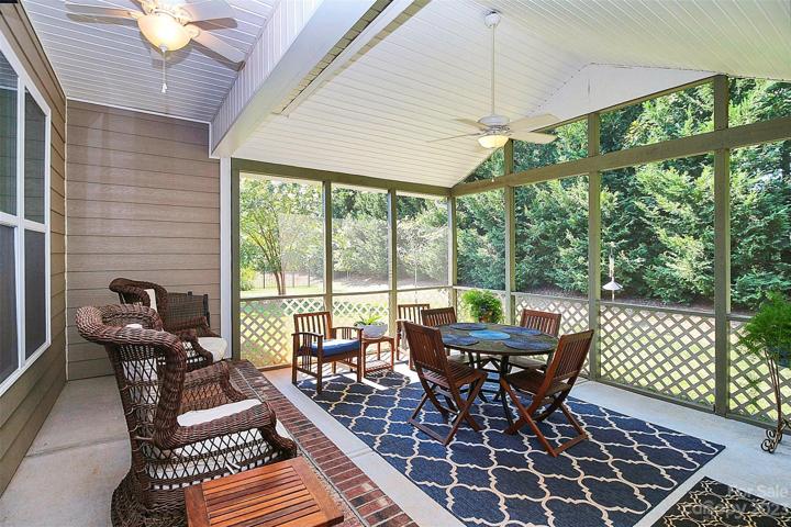 Screened in porch overlooking private yard.