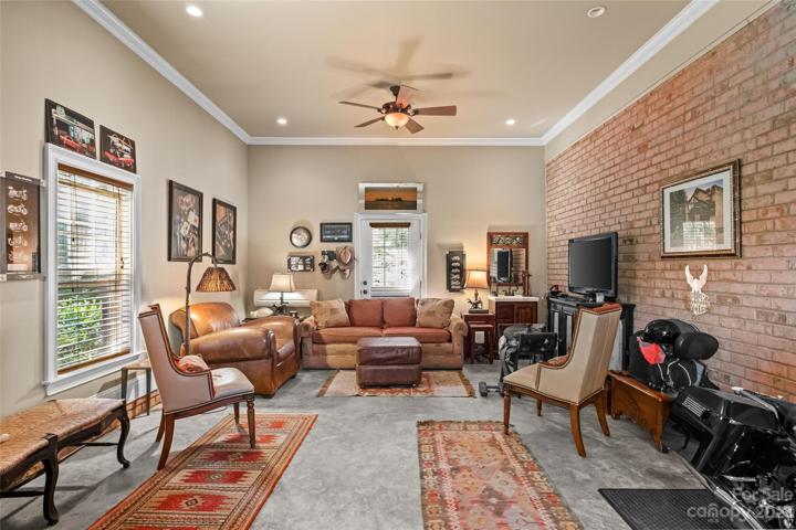Bonus space, measures 352, features a brick wall, a heating a cooling unit and extra space to hang out.