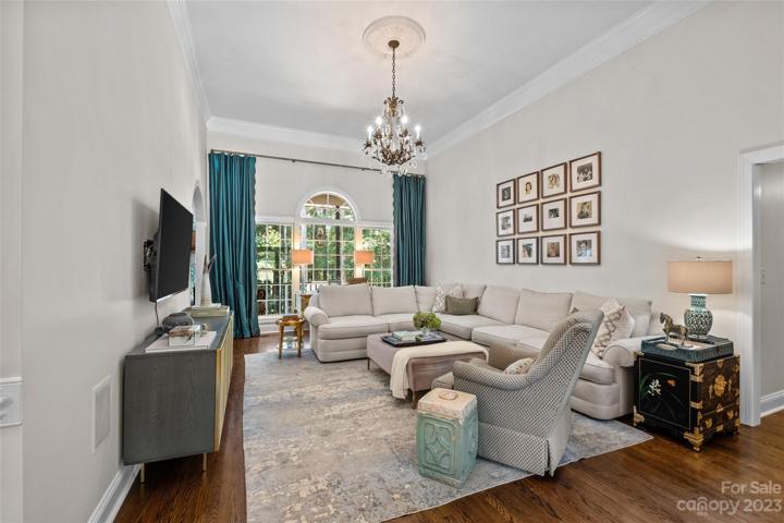 Bright and airy living room, oversized windows, high ceilings, oak floors
