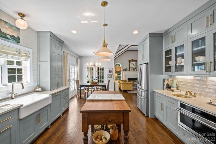 Fully renovated custom kitchen, outfitted with top of the line appliances, CB2 hardware, Kohler whitehaven enameled cast iron farm sink, Brizzo Luxe faucet in gold, brass bar sink, quartzite countertops and  a Custom Built Vintage Millworks wood island.