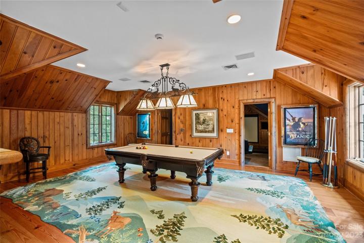 Game room with wood detail, wet bar & half bathroom.