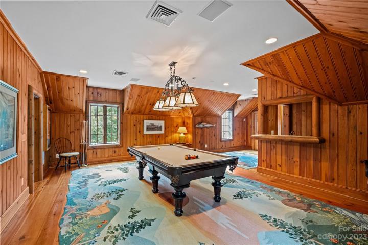 Game room with wood detail, wet bar & half bathroom.