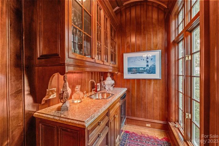 Study with mahogany wood throughout, builtins, fireplace & wet bar