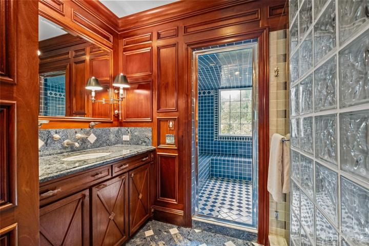Stunning primary suite with his & her bathrooms, heated floors, walk-in closets & covered balcony overlooking the incredible resort pool & private backyard.