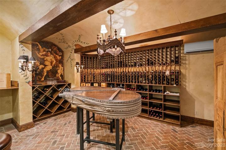 Spiral stairs lead to climate-controlled 900 bottle wine cellar.