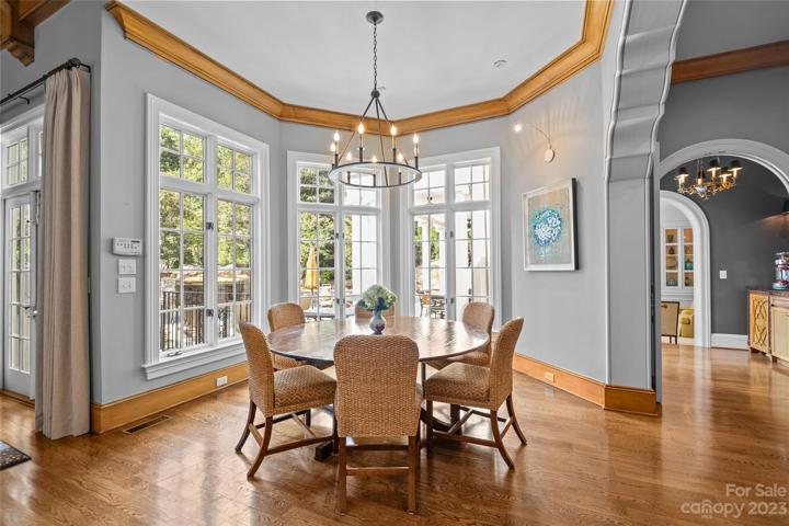 Perfectly positioned breakfast table dining area overlooking resort pool & lush backyard.