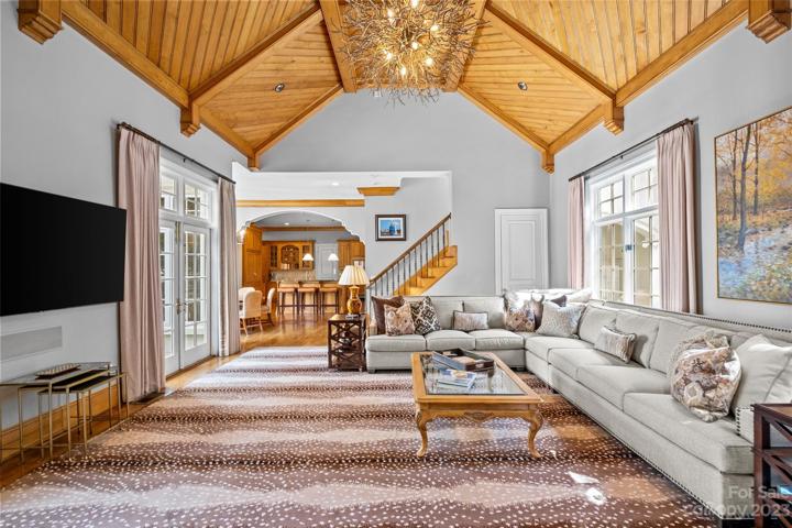 Two story family room with 17' ceilings, incredible wood detail, builtins & stone fireplace.