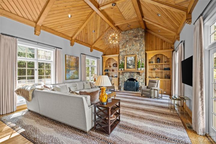 Two story family room with 17' ceilings, incredible wood detail, builtins & stone fireplace.