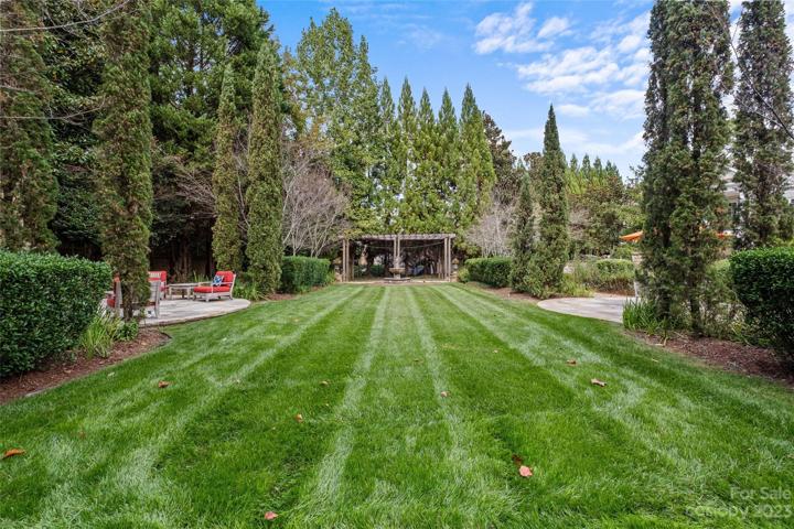 An entertainer's dream featuring incredible indoor/outdoor living spaces to enjoy all 4 seasons, resort pool with grotto spa, pool bath, outdoor fireplace, gardens with Charleston gates & many luxurious features throughout.