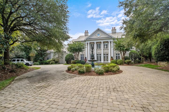 As you enter the estate, the inviting circular driveway with stunning fountain & grand column entrance greets you.