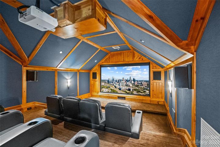 Movie theater with sound proofing upholstered walls & reclining theater seating.