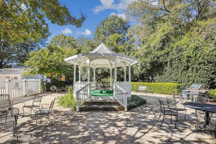 Gathering area with grill and gazebo.  Pool is on the left.