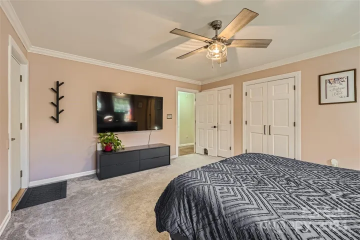 Primary bedroom with separate door to deck and hot tub