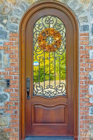 ...with an enchanting handmade Mahogany  door highlighted with iron accents...