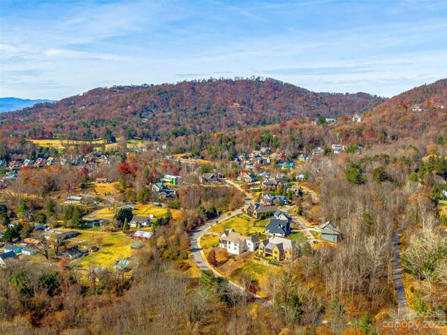 On the bottom right, the golden"ish" home (back of house - deck on top/terrace on bottom), 20 Snap Dragon Court is within minutes of the golf course (witness on the upper left), Beaver Lake, the Country Club of Asheville, the Grove Park Inn and all of the award winning amenities of downtown Asheville. Come live here~