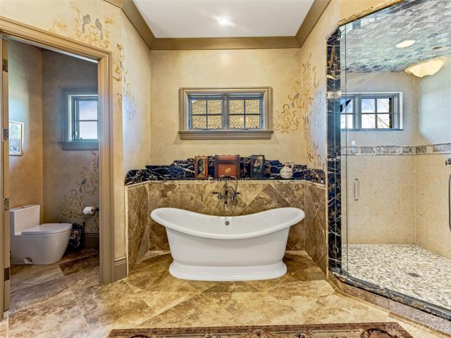 From the water closet to the pedestal tub to the low curb shower, the spa-like ambiance relaxes the spirit