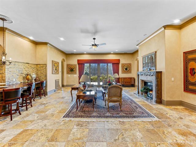 Welcome to your Family Recreation Room! As you travel past the inviting warmth of that unique fireplace, you may travel through those french doors to your Terrace...