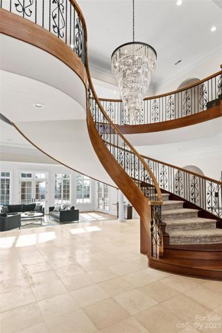 The grand staircase greets you and opens up to the 2-story great room
