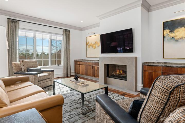 Beautiful black walnut cabinets to match the black walnut hardwoods and re-imagined fireplace surround in a sleek concrete set the tone for this cozy space