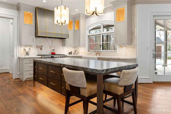 Completely updated kitchen and keeping room boast new appliances, custom cabinets and range hood, stunning lighting and re-faced fireplace