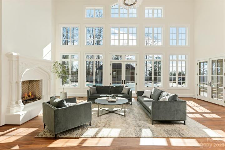 Gorgeous natural light from the wall of windows fills the heart of the home