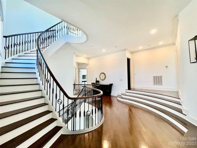 Gracious elegance abounds on the second floor landing with stairs continuing up to the 3rd floor rooftop covered patio.