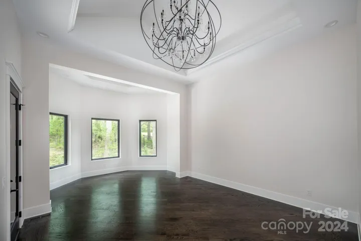 Primary suite with bay window overlooking a beautiful wooded area