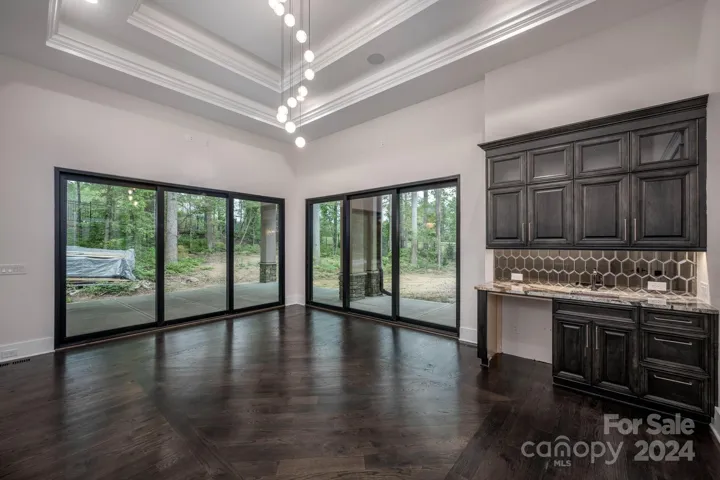 Game room or flex space with double tray ceiling & stunning light fixture