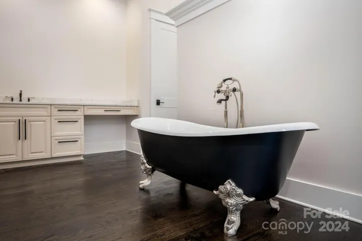 Primary bath with mother-of-pearl tub and dual sinks
