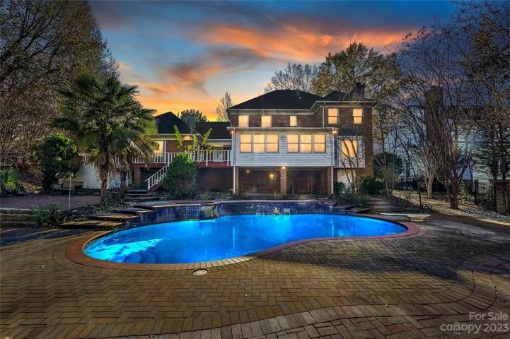 Rear of the home and pool at dusk