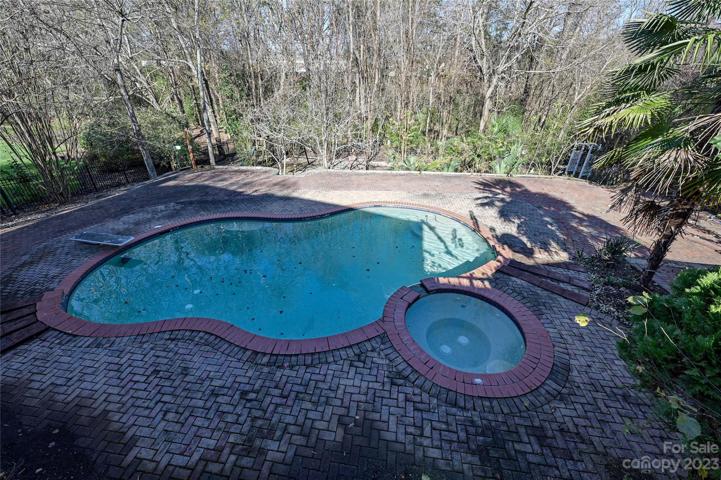 Pool and Jacuzzi with huge brick paver deck and rear yard
