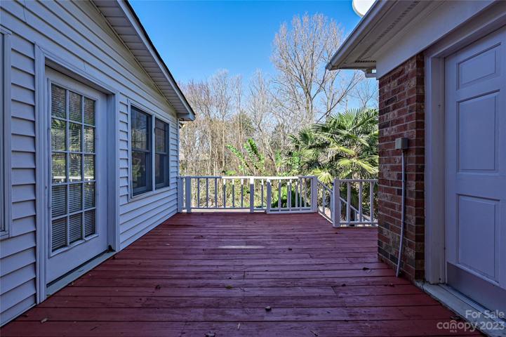 Rear deck overlooking pool and paver patio