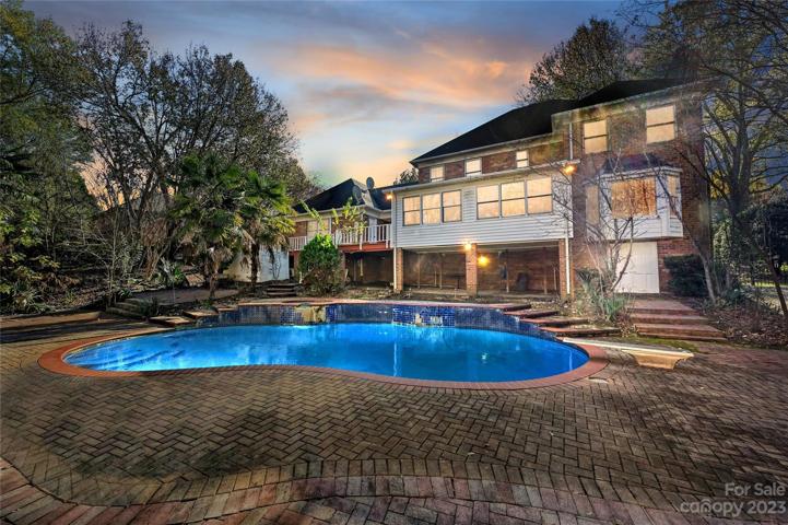 Pool and rear home view at dusk