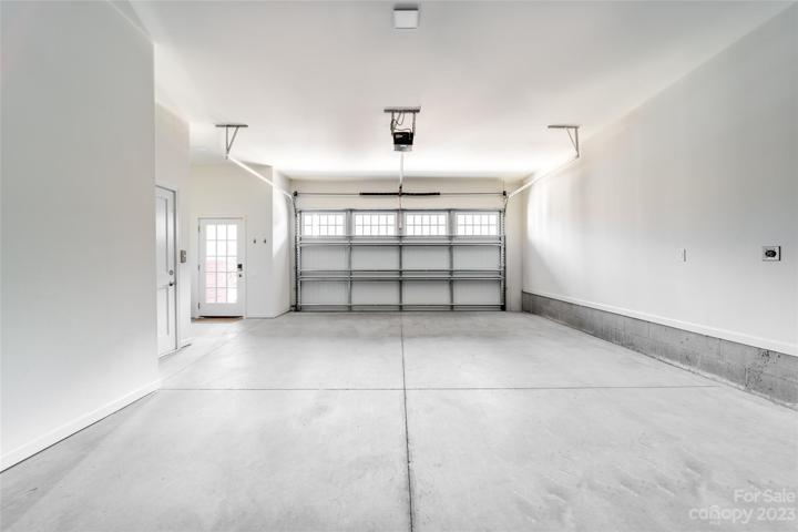 spacious 3 car tandem garage and storage with elevator access to home