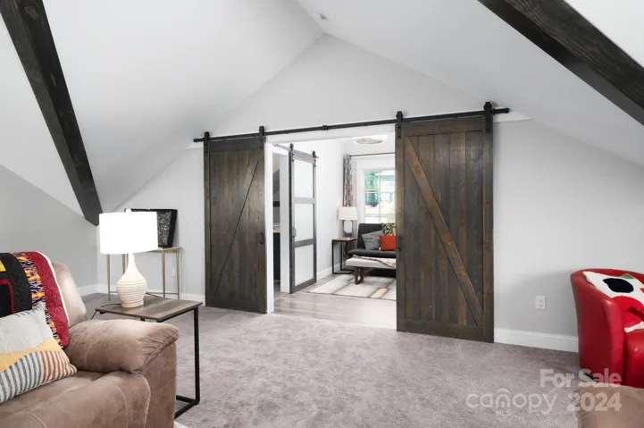 Modern Barn Doors Lead to Additional Flex Space Above the Garage