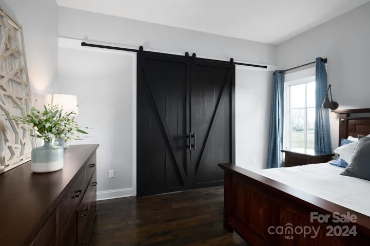 Modern Sliding Barn Doors in Primary Suite Lead to an Attached Office or Sitting Room