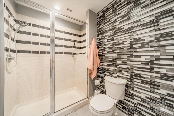 Large stand up shower with porcelain tile.