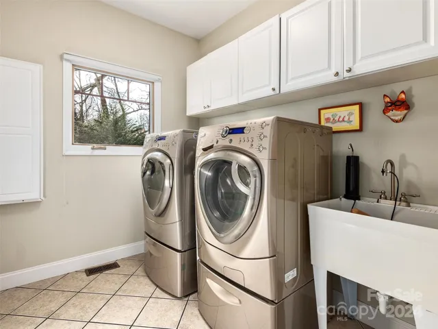 Laundry with pull down ironing board