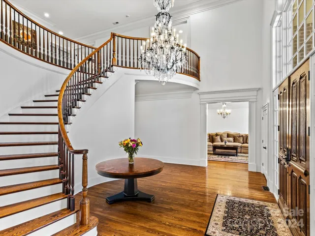 Foyer, Grand Staircase and Biltmore Rendition Hand Carved Entry doors.