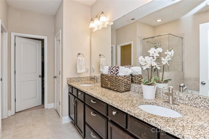 Primary bathroom with dual sinks with granite counters