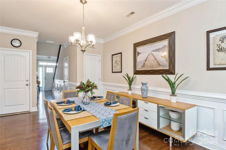 Dining Room has hardwood floors and chair rail and picture  molding