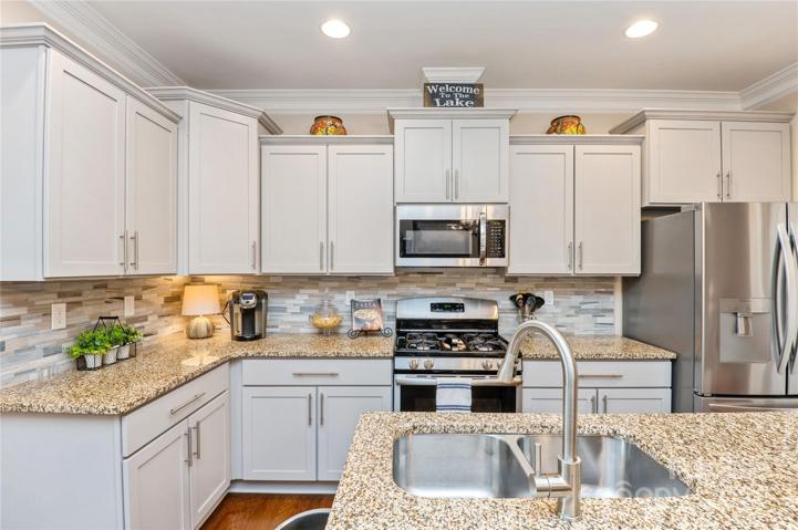 New cabinet doors, gas stove and new backsplash
